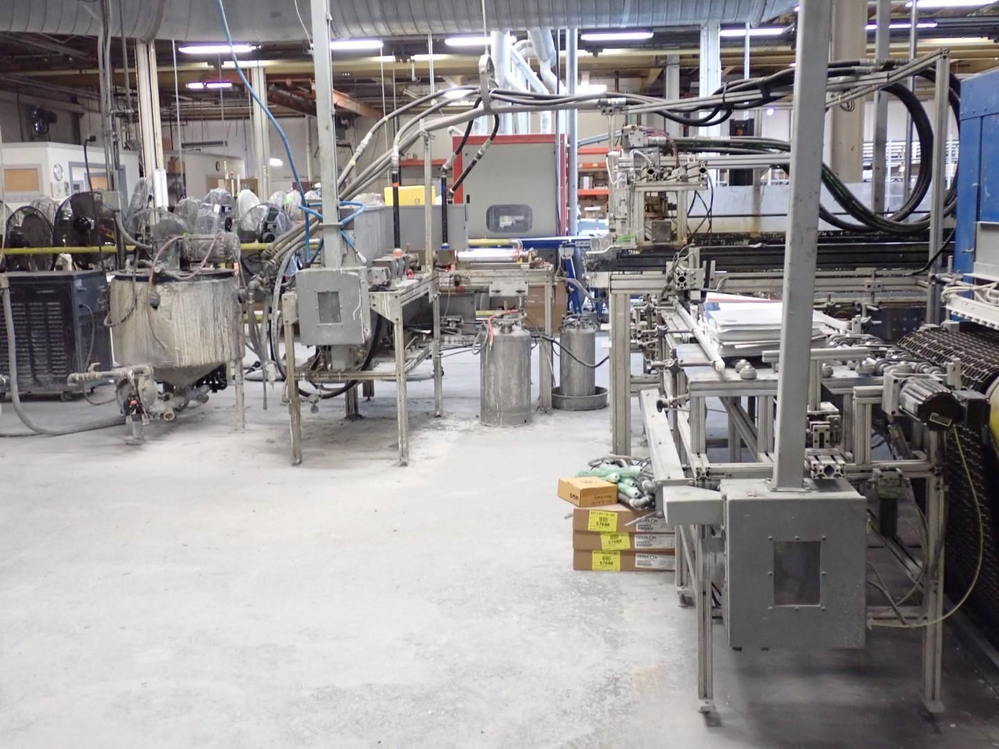 Industrial machinery in a factory setting. Production line with multiple interconnected machines, various metal components.
