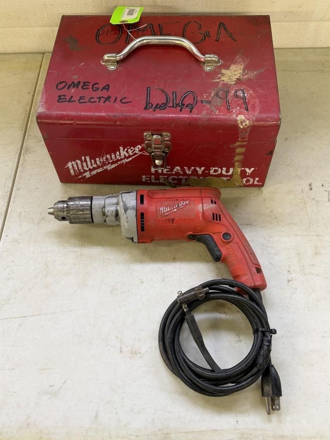 Red Milwaukee drill with toolbox on a surface.
