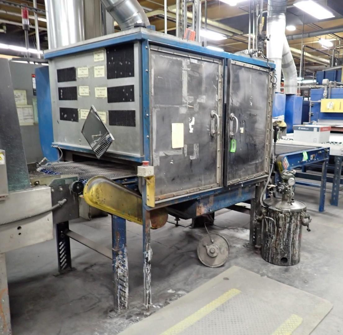 Industrial machine with gray and blue enclosure, conveyor belt, and exhaust duct in a factory setting.