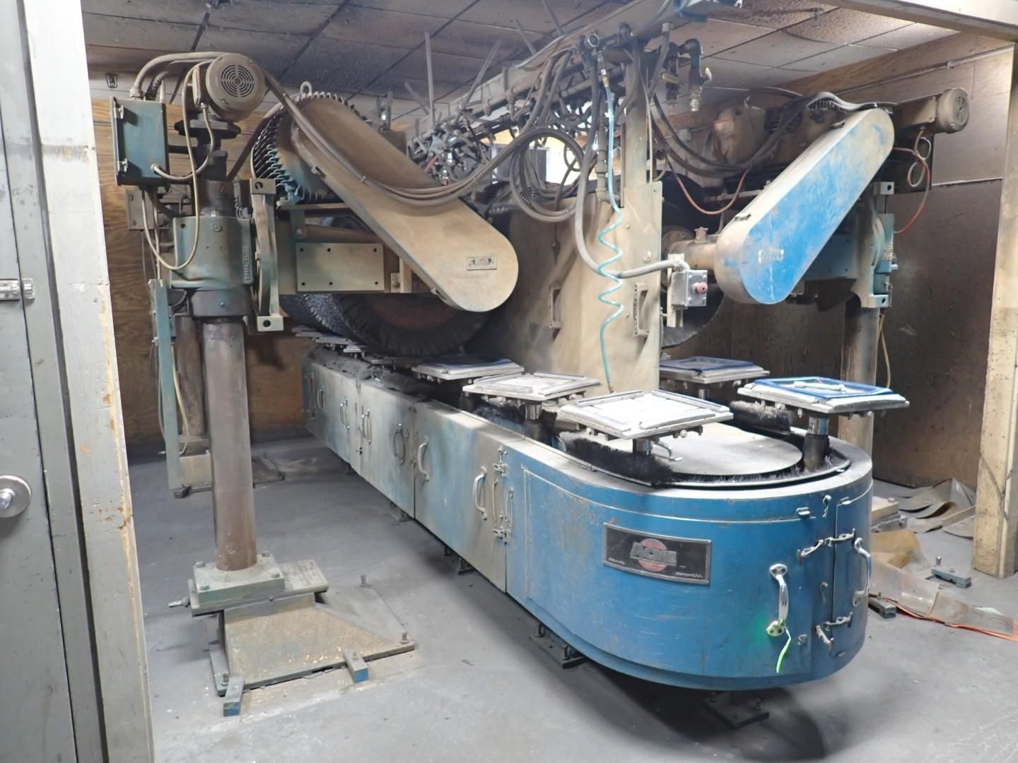 Large blue industrial machine with conveyor belt, used for processing materials.