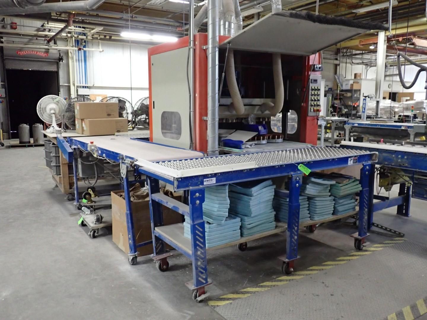 Production line machine with conveyor belts, red and beige machinery, blue metal frames, factory setting.