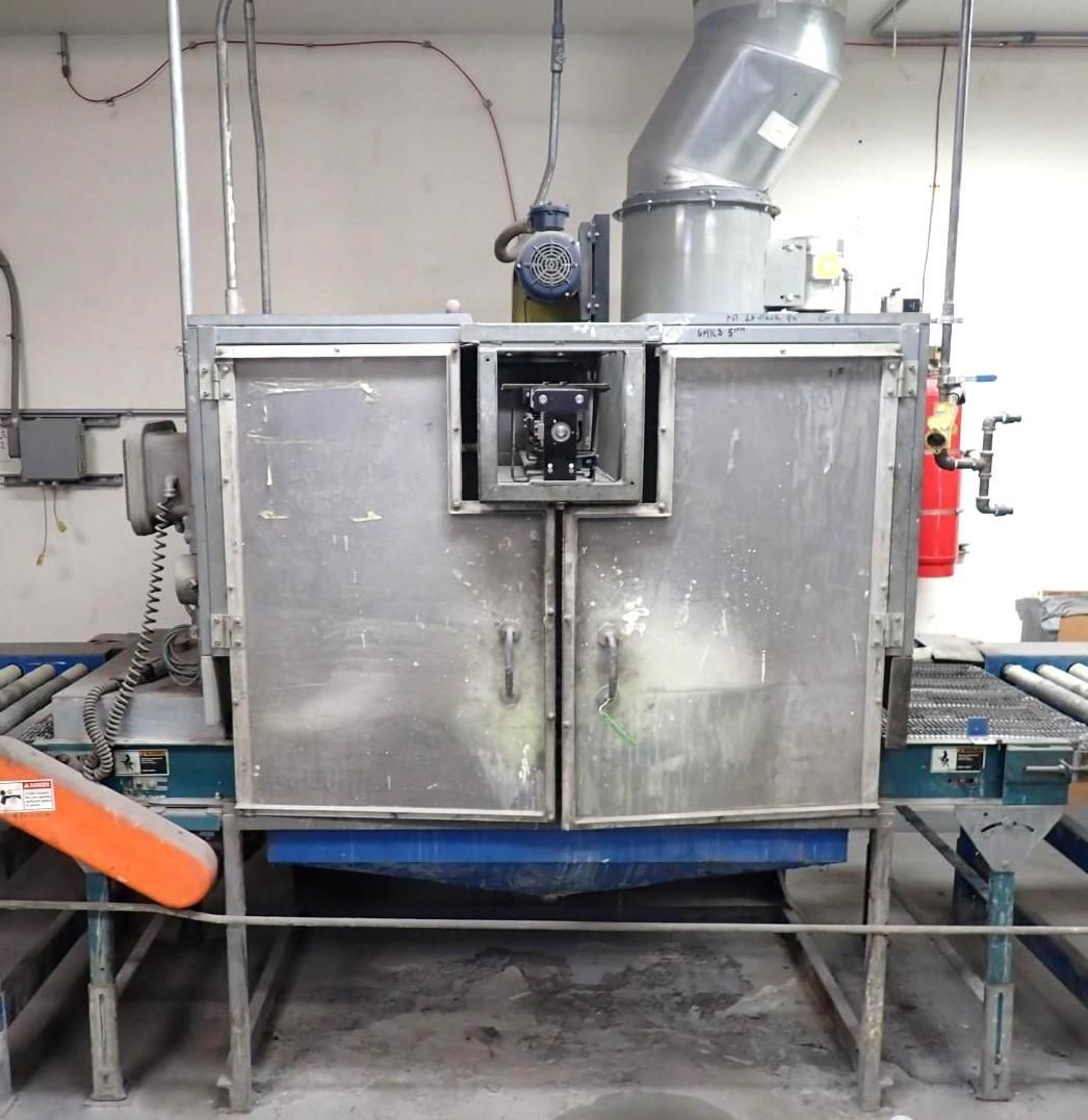 Industrial machine with doors, a blower, and a conveyor belt.