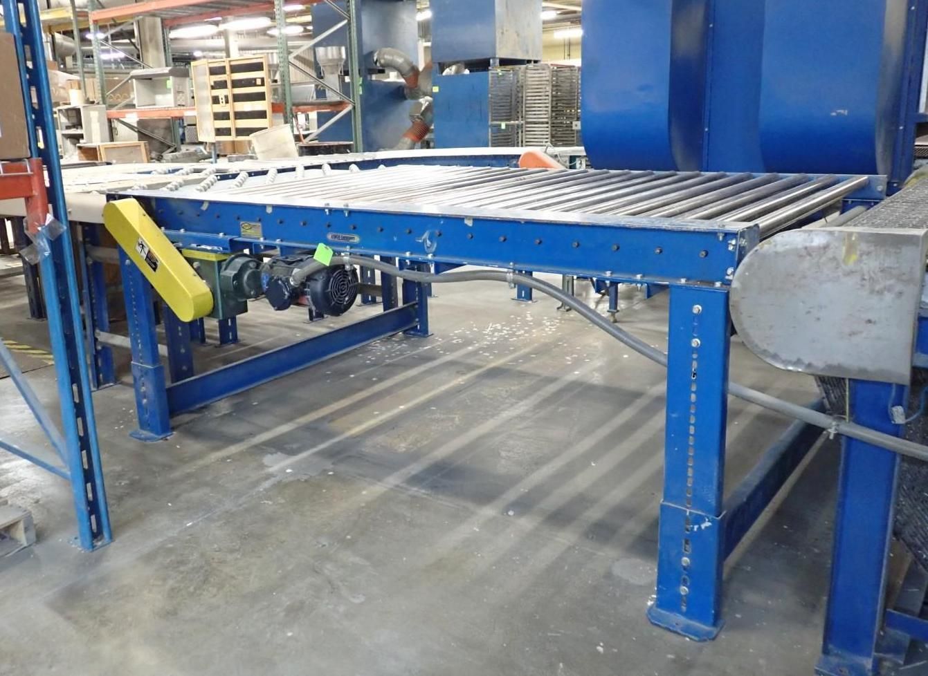 Blue industrial roller conveyor in a warehouse.