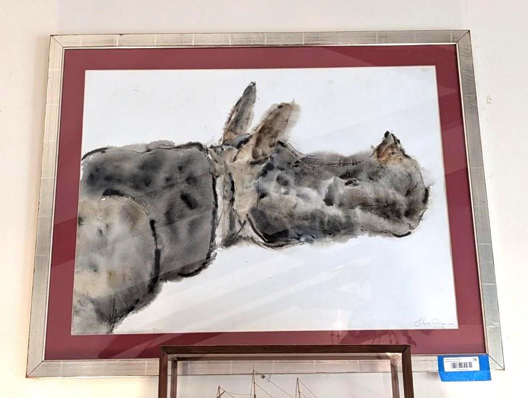 A framed watercolor painting of a gray, textured animal seen from the side, mounted against a deep red background.