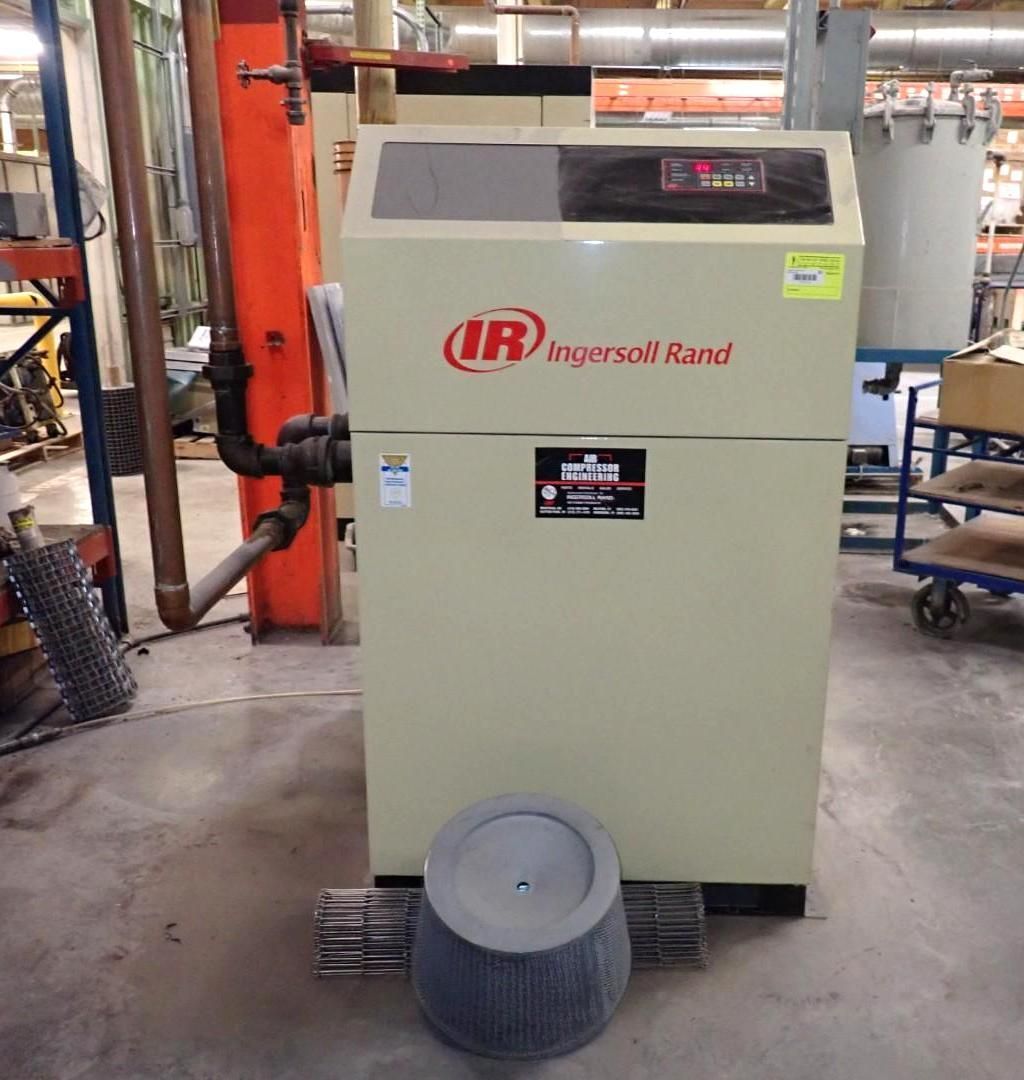 Tan Ingersoll Rand air compressor with filter, indoors.