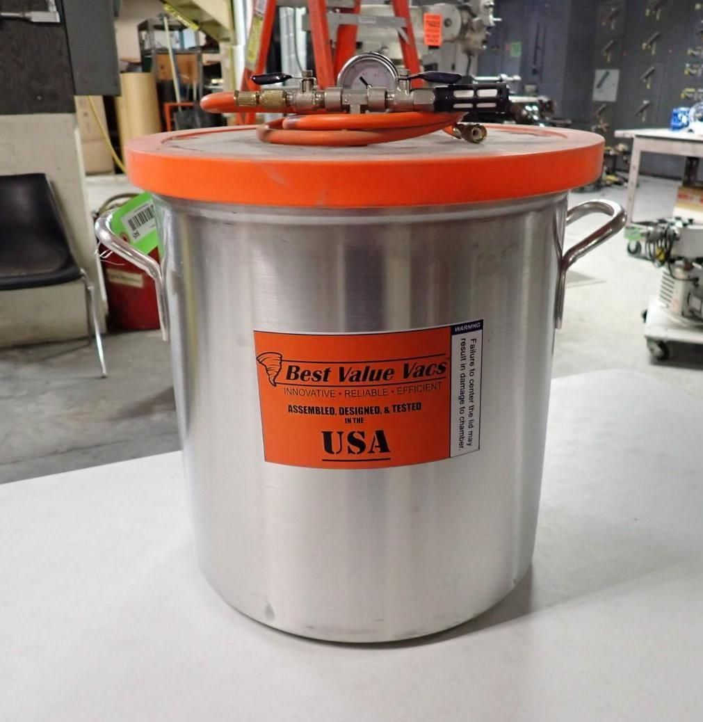 Silver vacuum chamber with orange lid, handles, and fittings; 