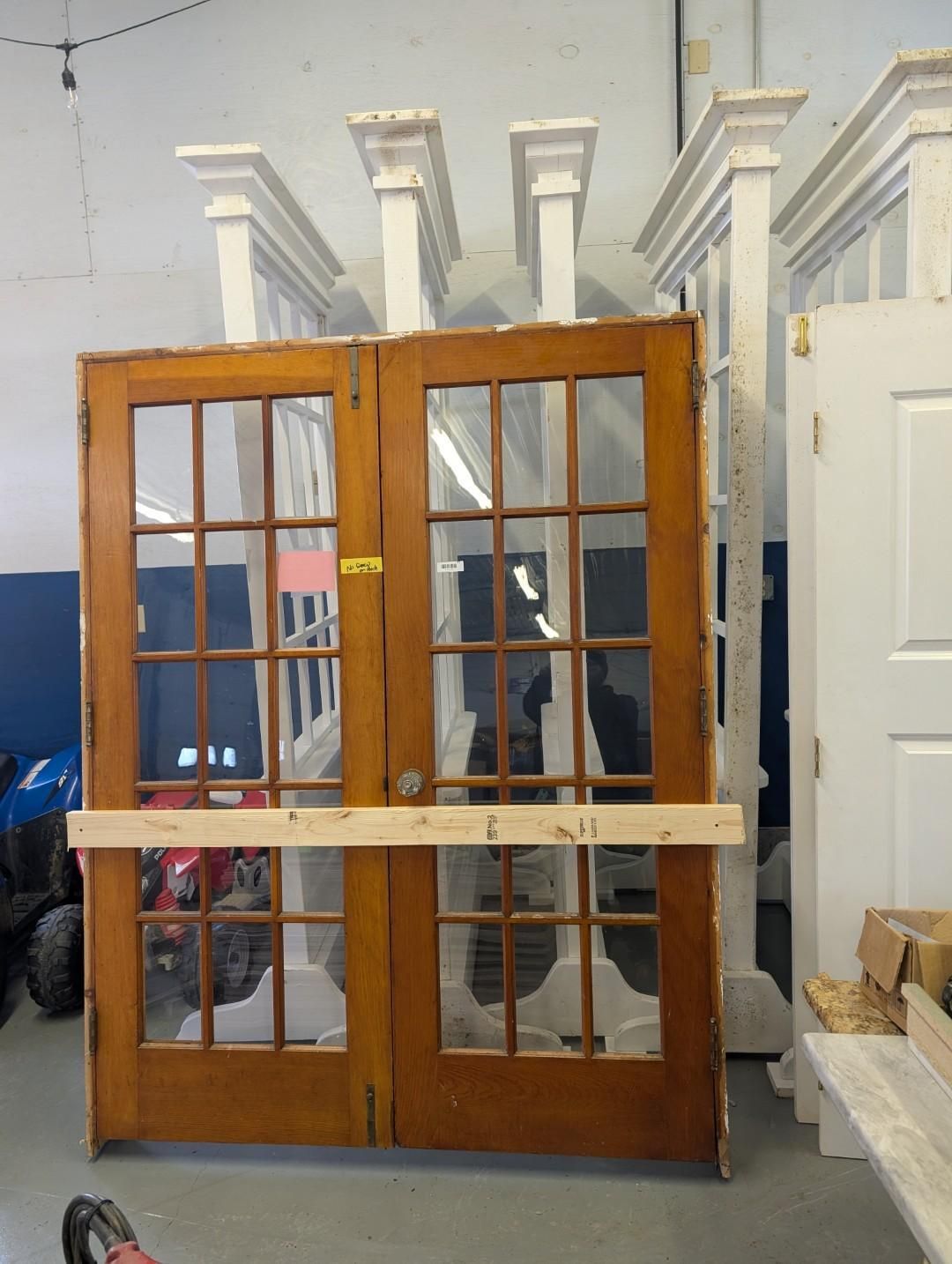 Wooden double doors with glass panes.