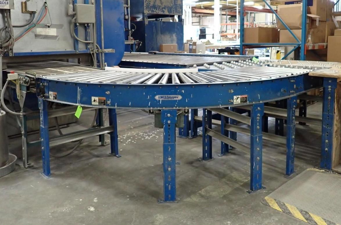 Blue curved roller conveyor in a warehouse.