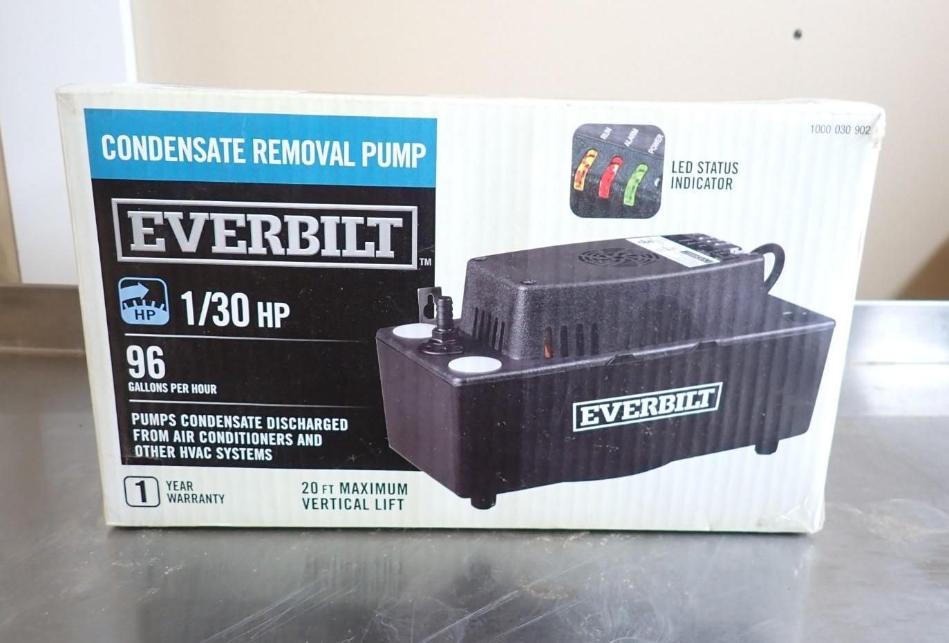 An Everbilt 1/30 HP condensate removal pump in its retail box, sitting on a metallic surface.