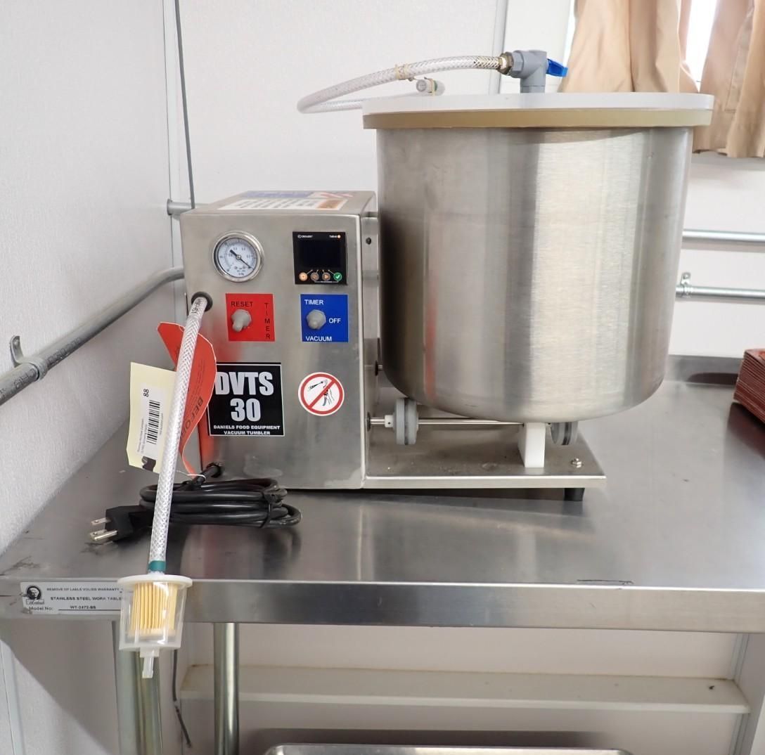 A stainless steel vacuum investment mixer for dental laboratory use, featuring a pressure gauge and digital controller.