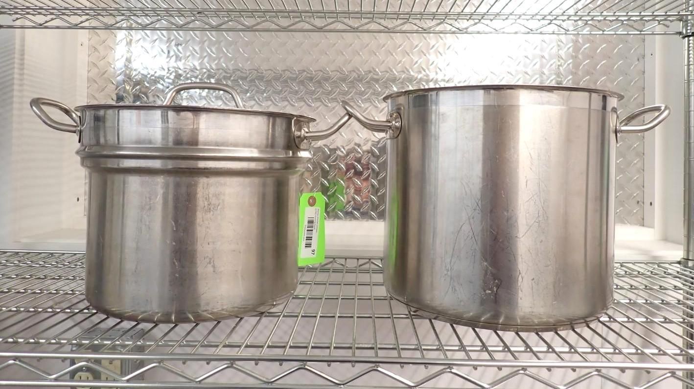 Two stainless steel pots sitting on a wire rack against a metallic diamond-plate background.