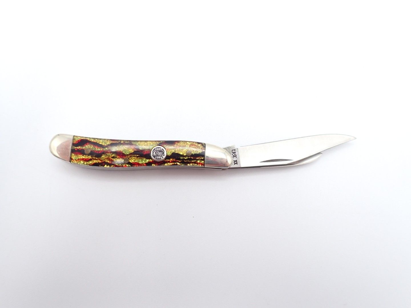 Small pocket knife with a multicolored marbled handle and a silver blade on a white background