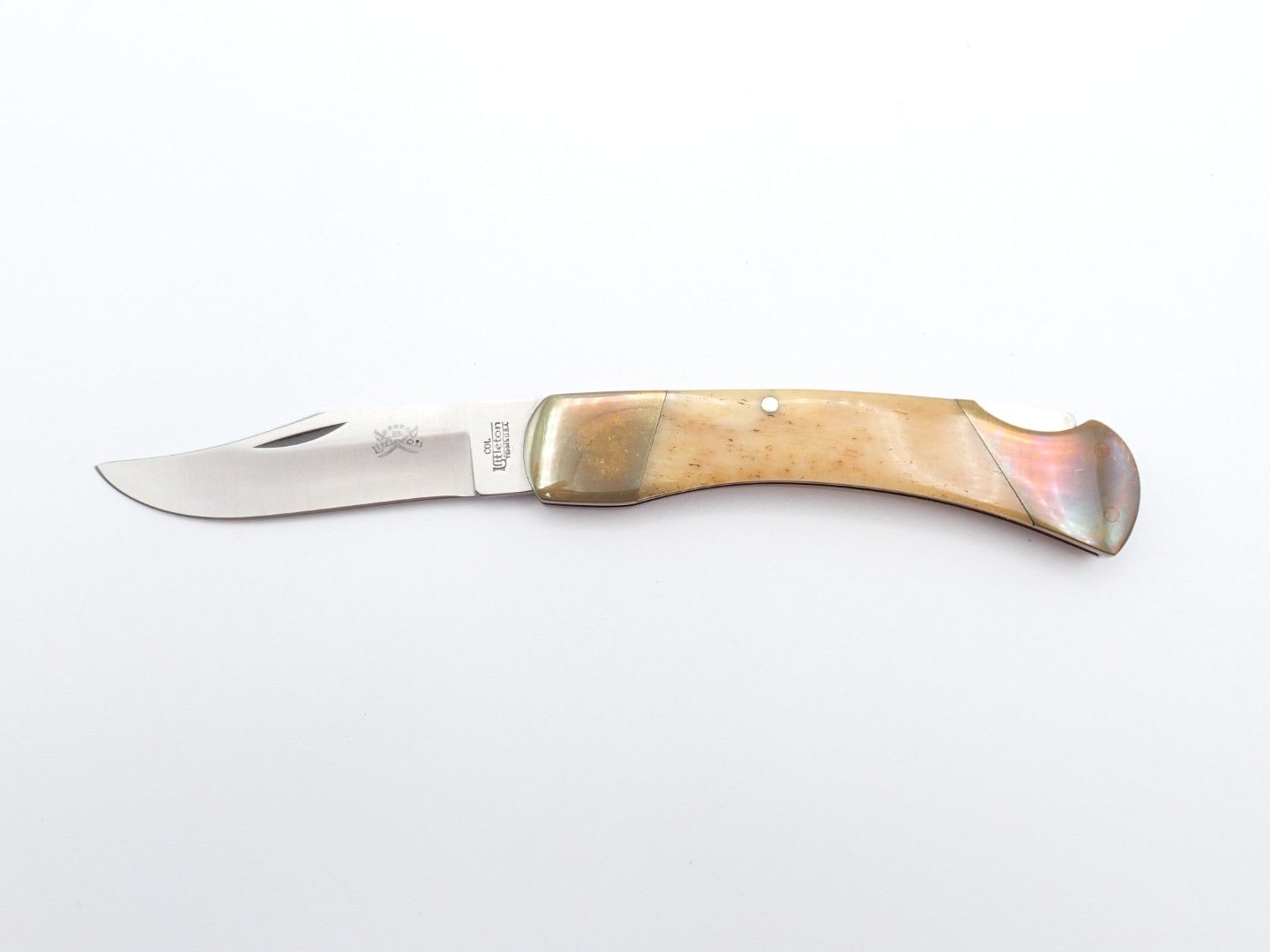 Pocket knife with a silver blade and light wood handle on a white background