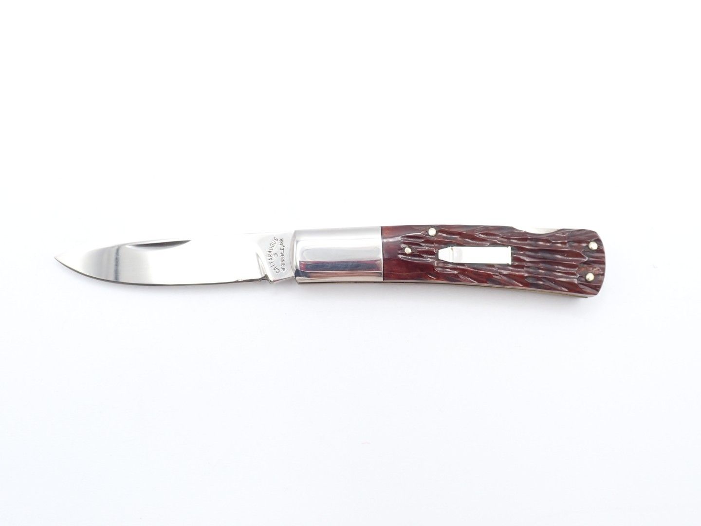 Curved pocket knife with brown wood handle and silver blade on white background