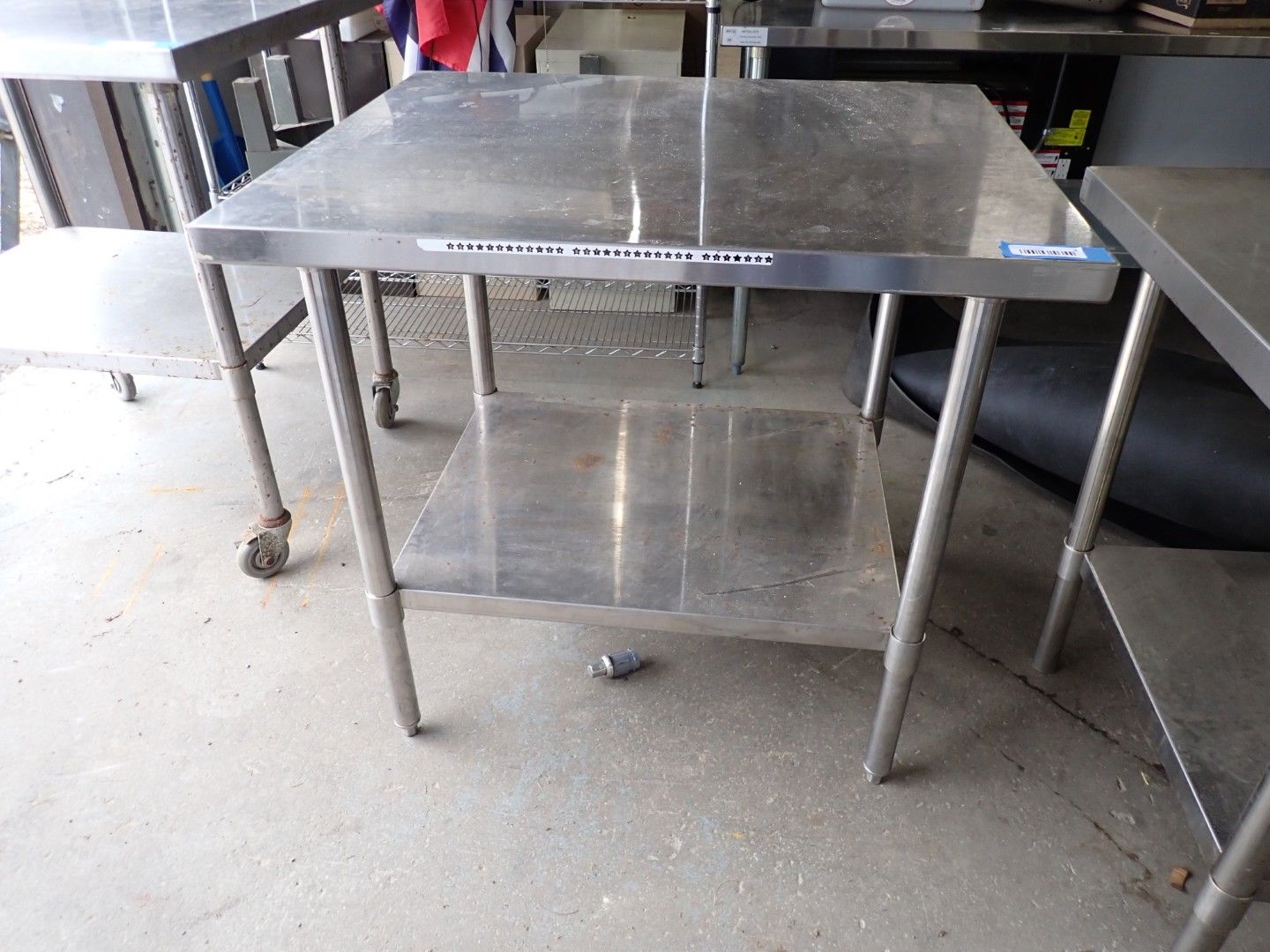 Stainless steel work table with lower shelf.
