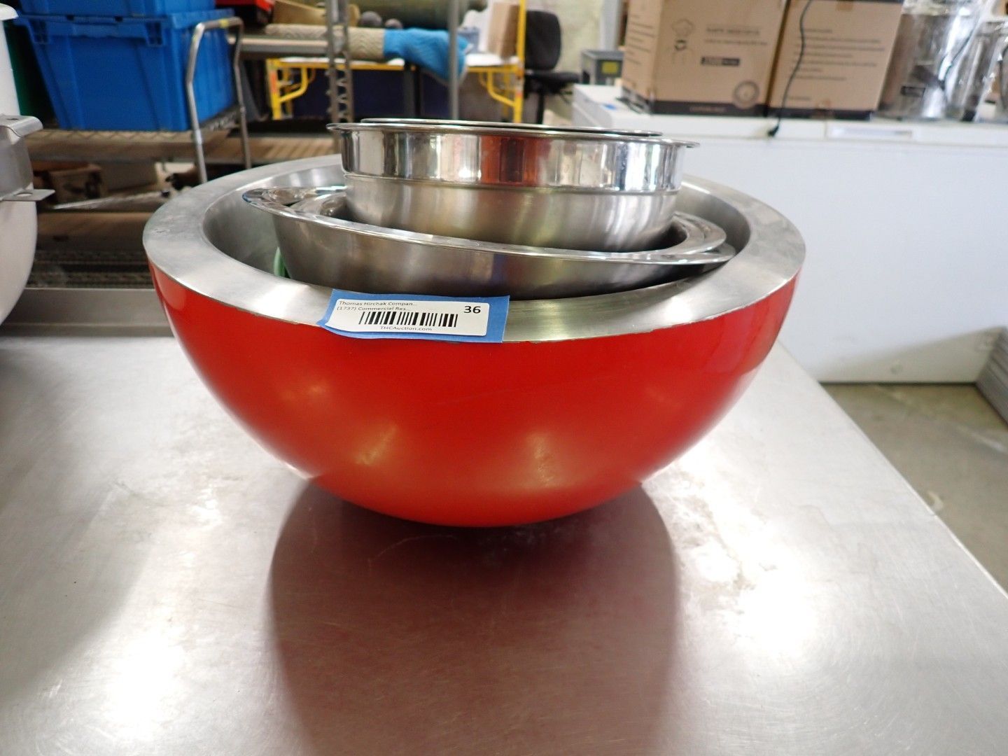 Red mixing bowl with a metal bowl nested inside on a kitchen counter.