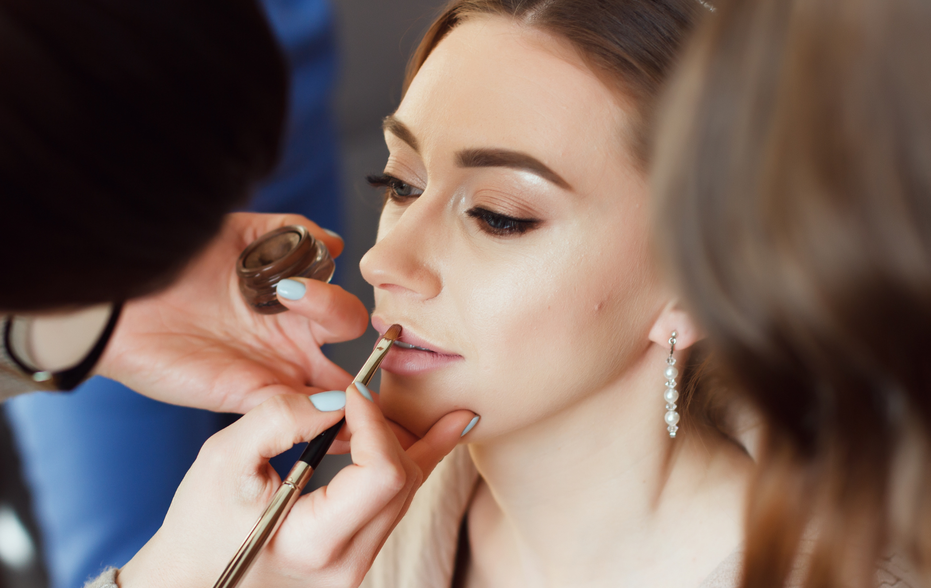A close up of a woman 's eye with long eyelashes and freckles.