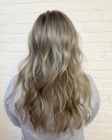 A close up of a woman 's eye with long eyelashes and freckles.