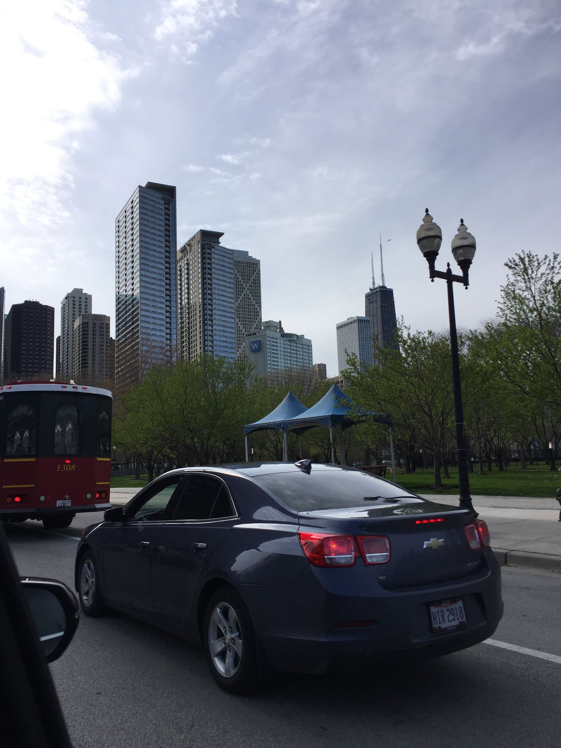 A dining room with a table and chairs and a wooden staircase.