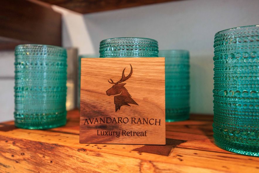 Avandaro Ranch branded wood logo and glassware inside a cabin kitchenette