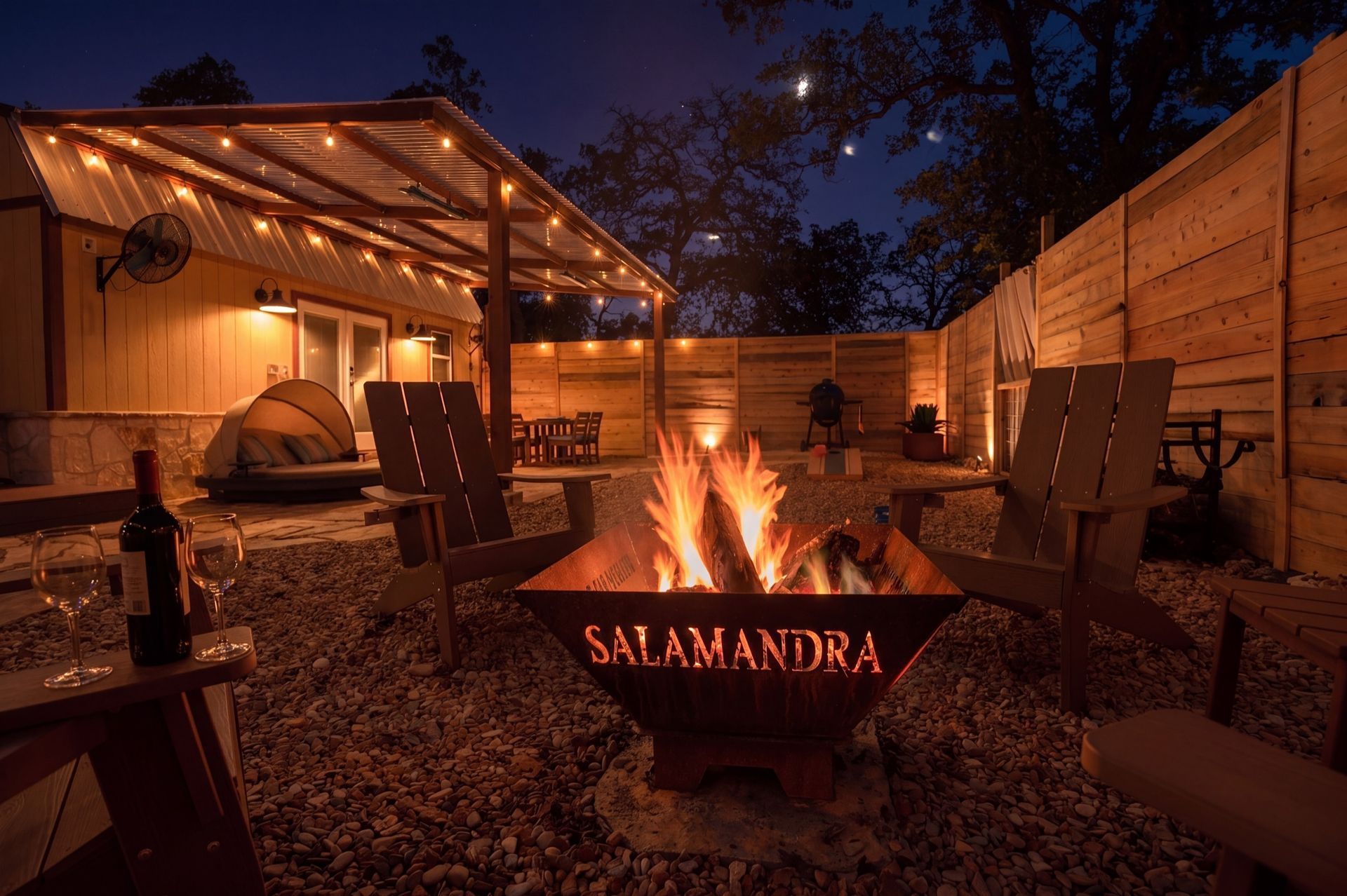 Name-branded fire pit burning at night under the stars at Salamandra cabin