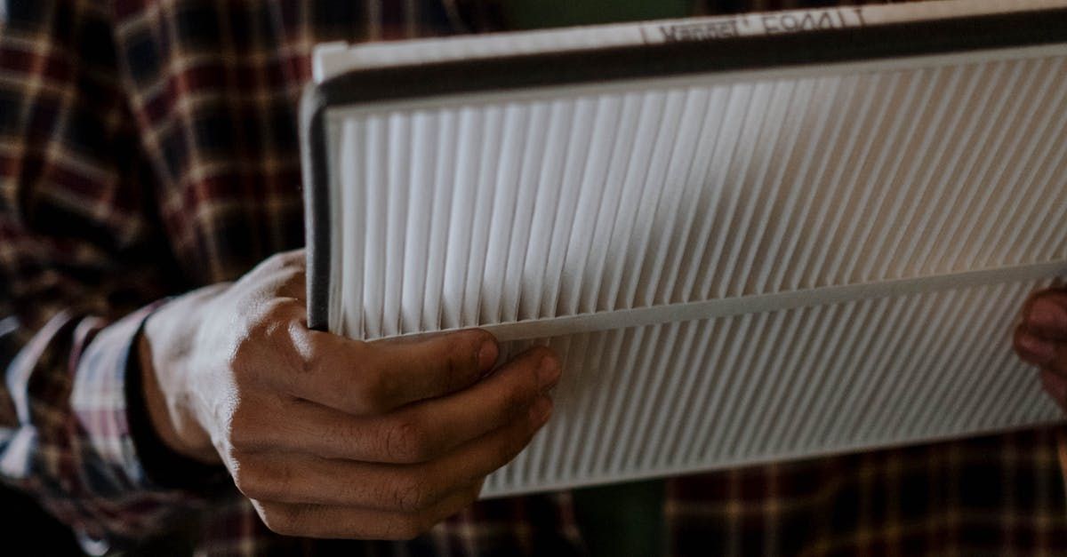 a man is working on an air conditioner outside of a brick building .