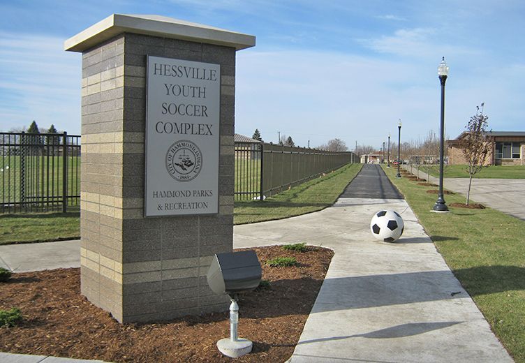 Sign for Hessville Youth Soccer Complex with a soccer ball on a path.