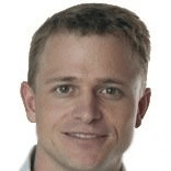 A close up of a man 's face with a smile on his face.