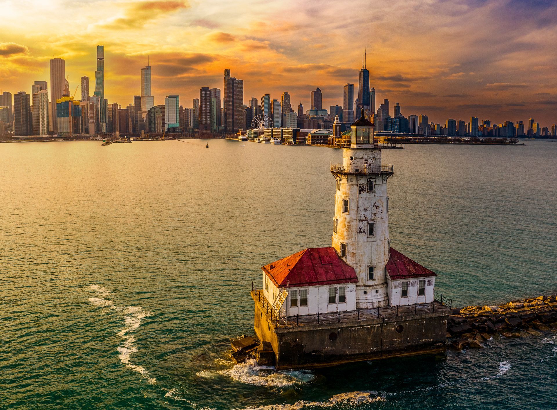 Woman with curly hair, wearing a hat, leans out of a car window with arms raised and a joyful expression. 
