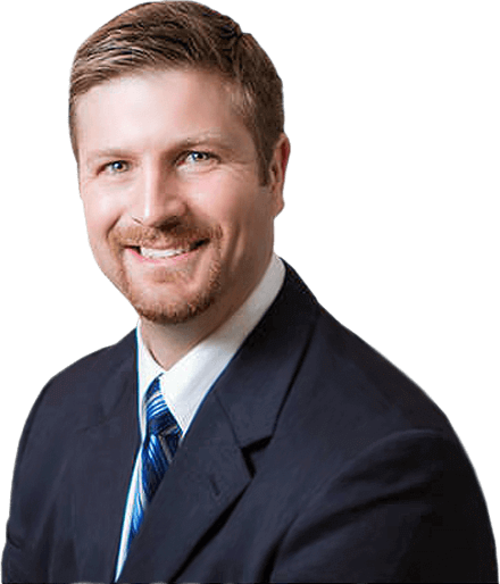 A man in a suit and tie is smiling for the camera.
