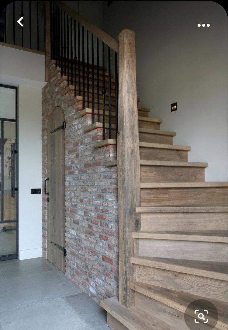 Workers replacing roof on a two-story house; one on a ladder, others on the roof. Bright sunny day.