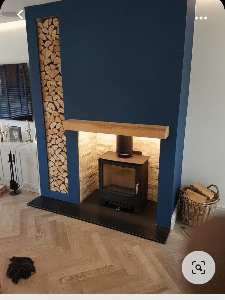 Modern two-story house with white stucco, wood accents, large windows, and manicured lawn at sunset.