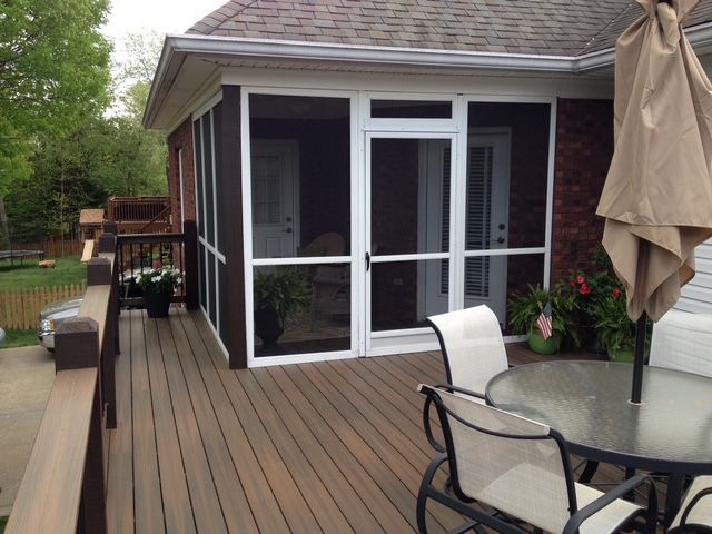 A large pile of discarded clothing, shoes, and various household items sits in an untidy heap on a light-colored floor.