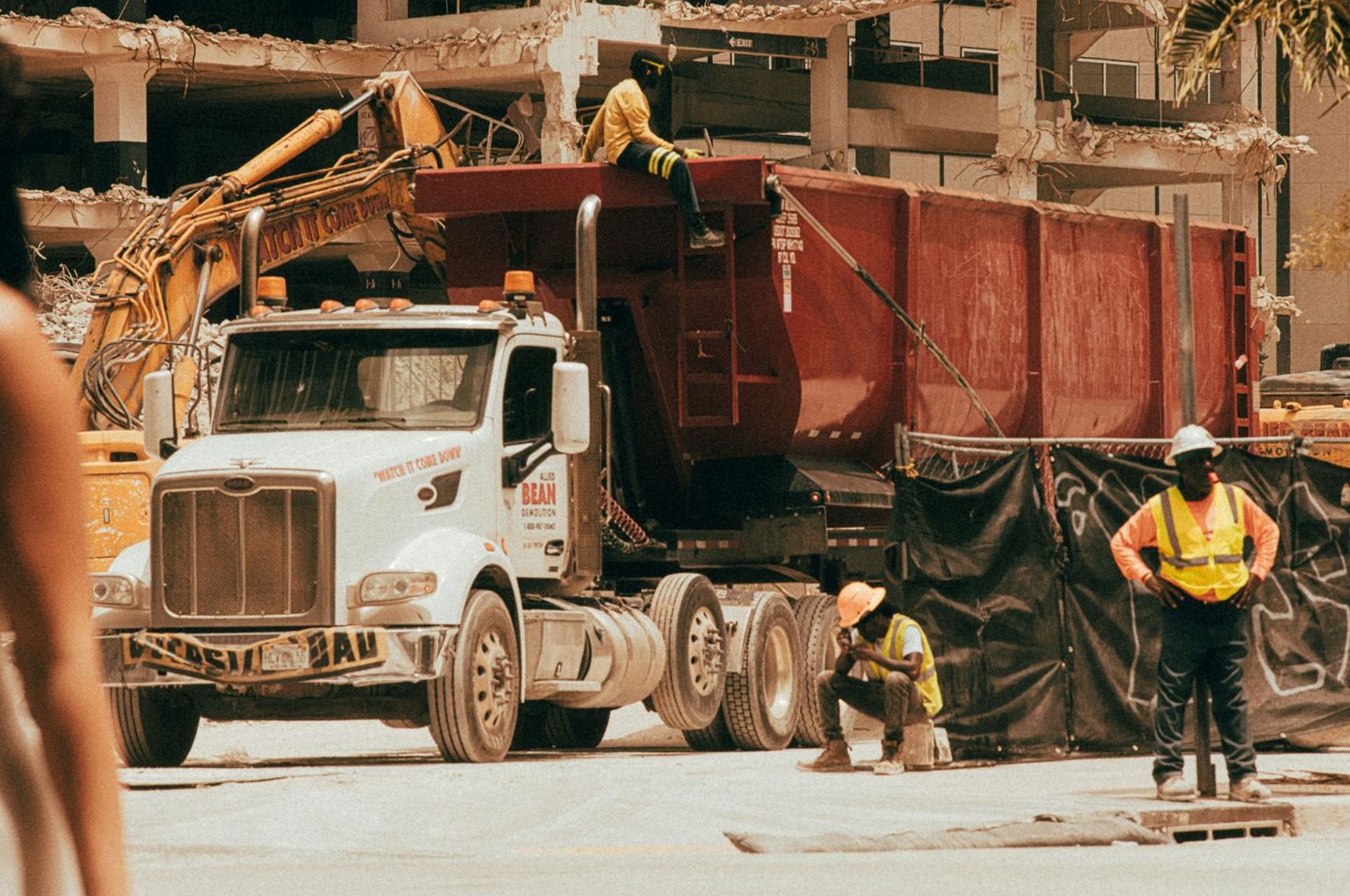 Workers operating a dump truck