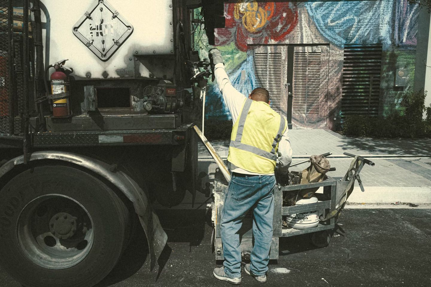 Dump truck worker loading up trash