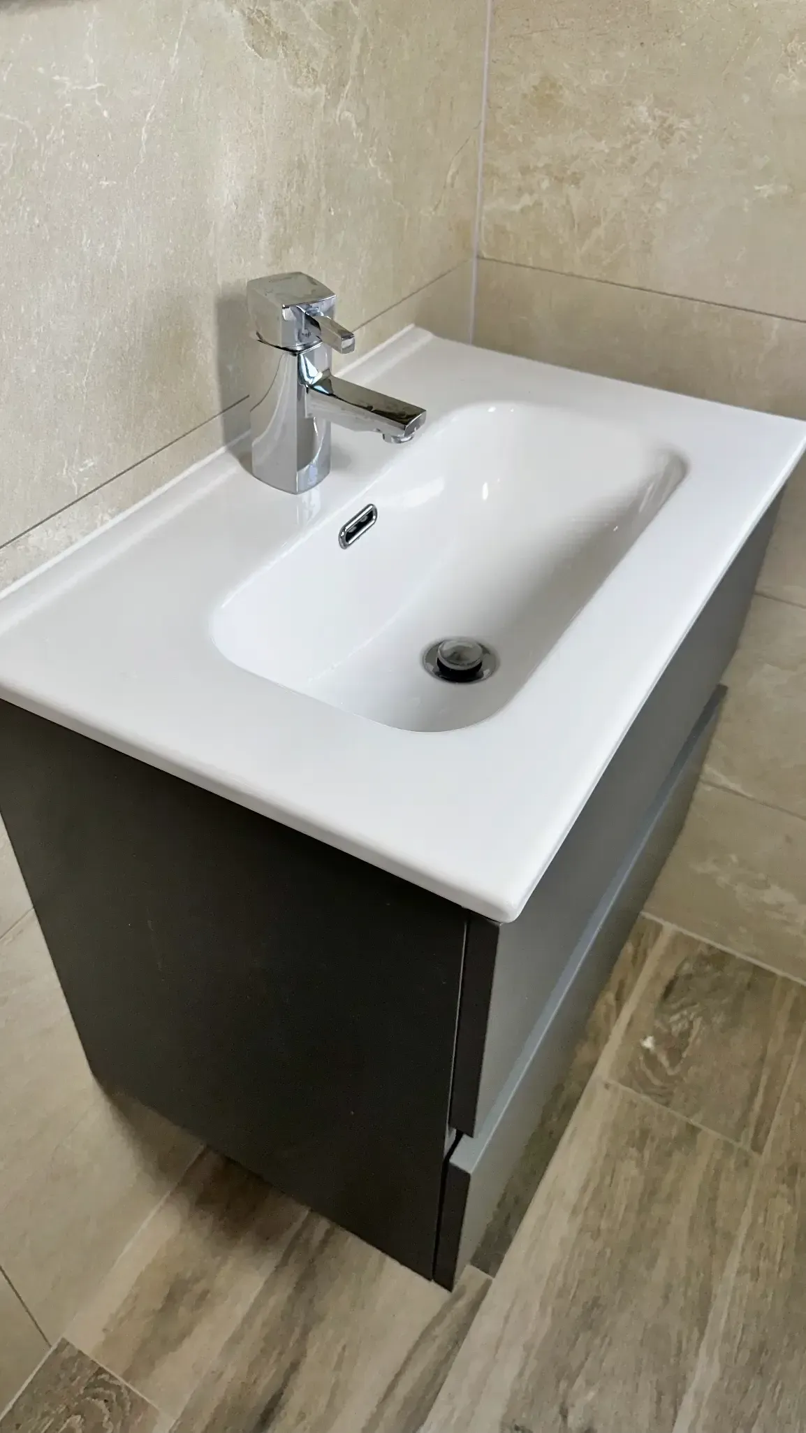 A bathroom sink with a faucet on top of it.
