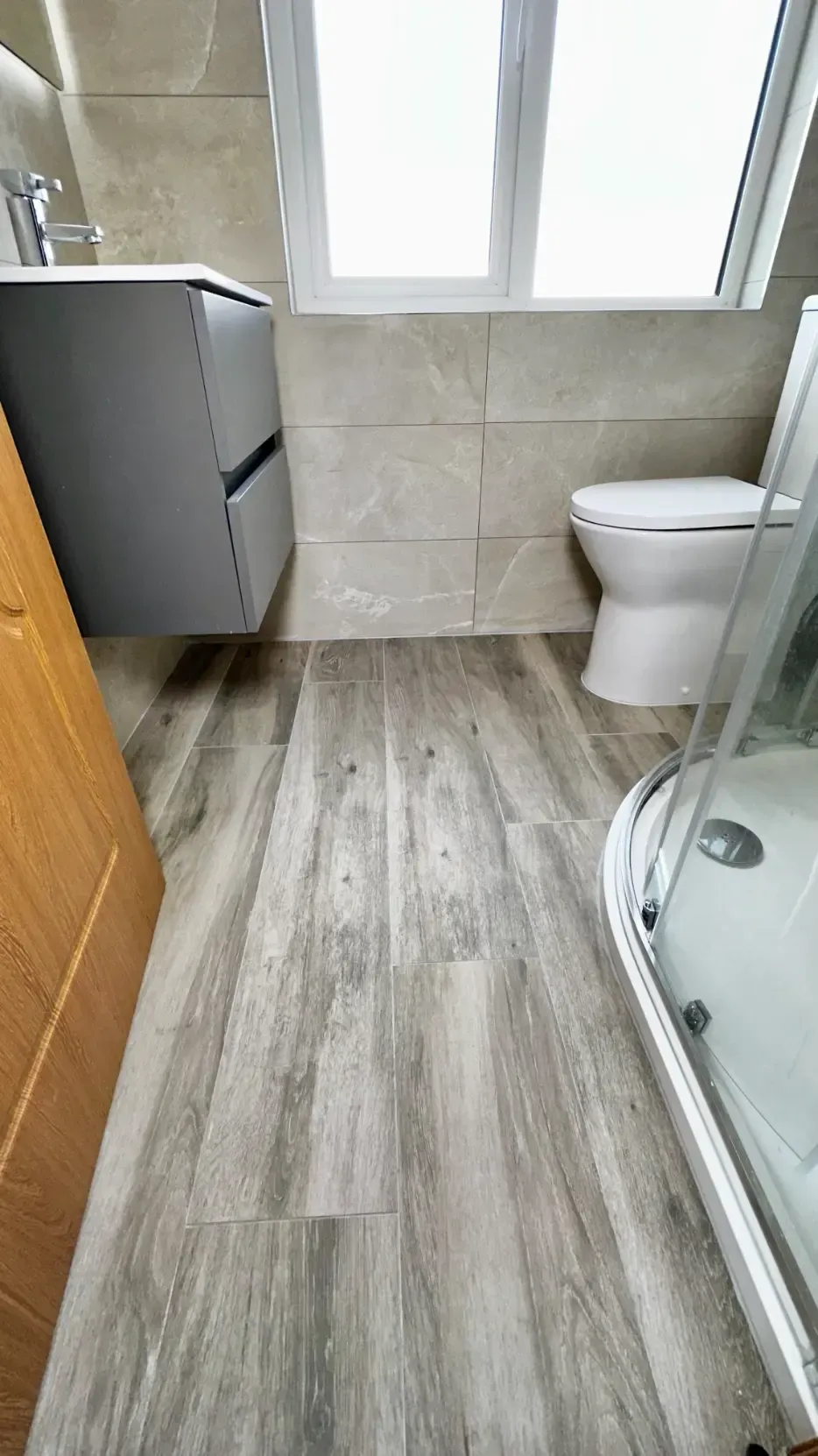 A bathroom with a toilet , sink , and shower.