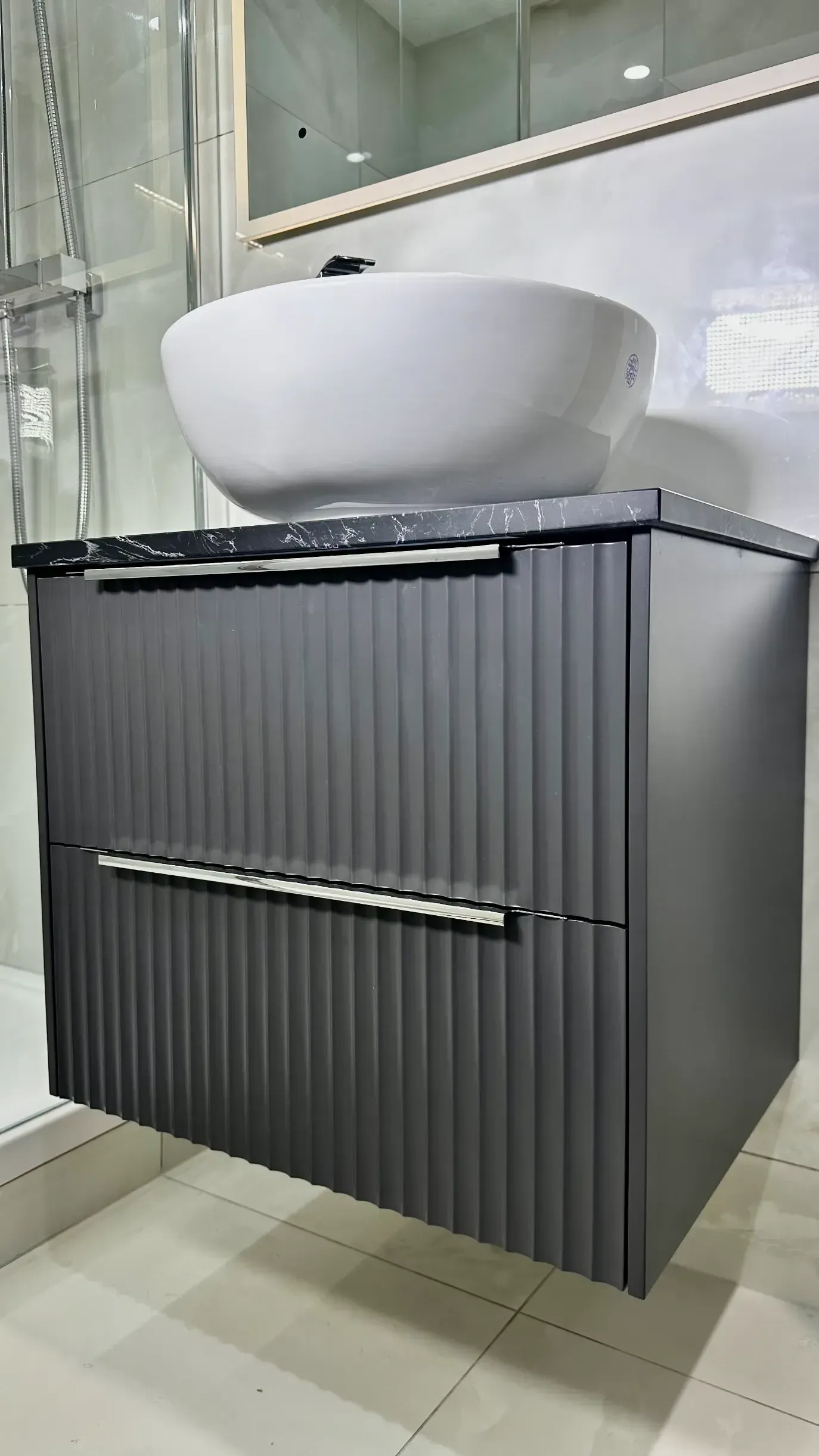 A bathroom vanity with a sink and a mirror.