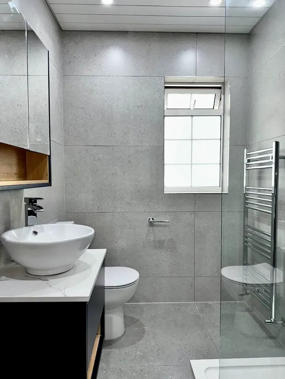 A bathroom with a sink , toilet , and shower.