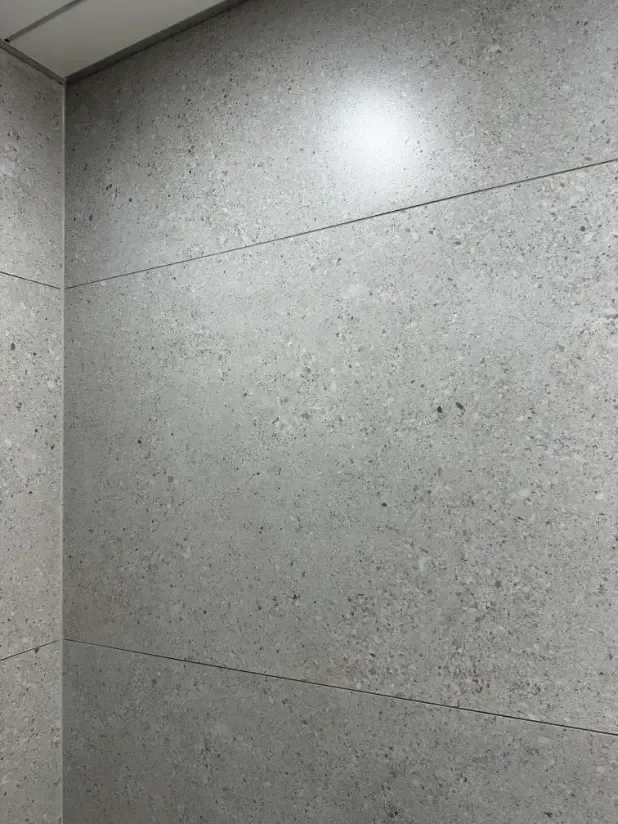 A close up of a wall with a lot of tiles on it.