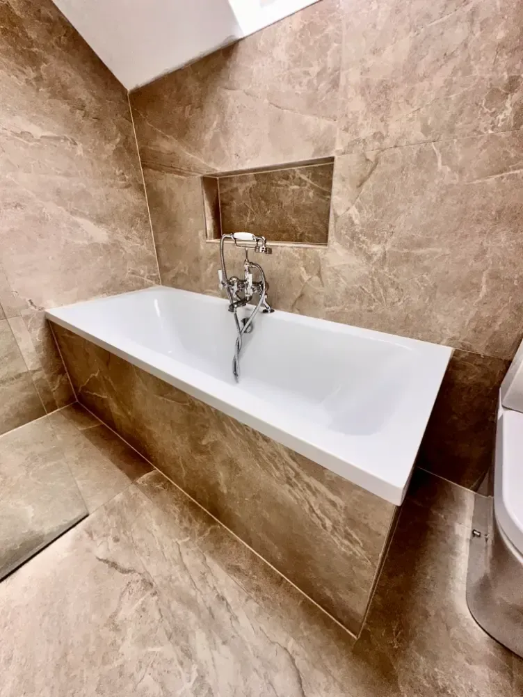 A bathroom with a bathtub and a toilet.