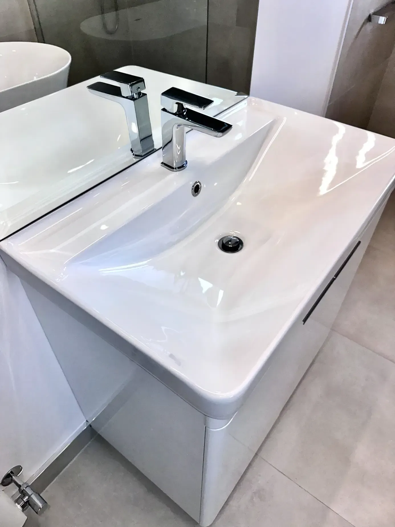 A bathroom sink with a mirror and two sinks.