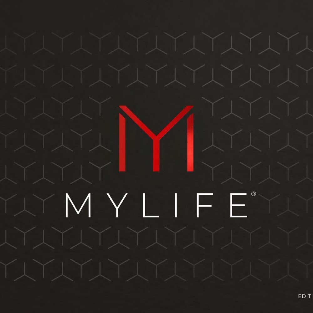 A bathroom with a bathtub , sink and mirror.