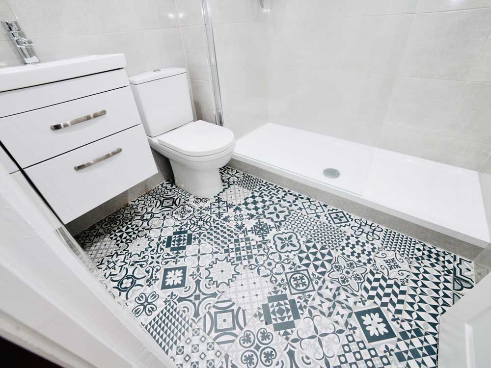 A bathroom with a toilet , sink , and shower.