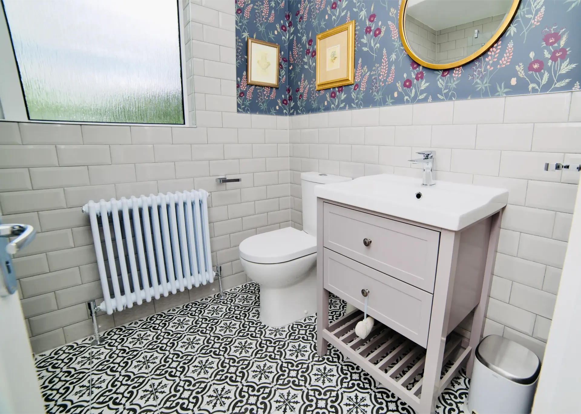 A bathroom with a toilet , sink and mirror