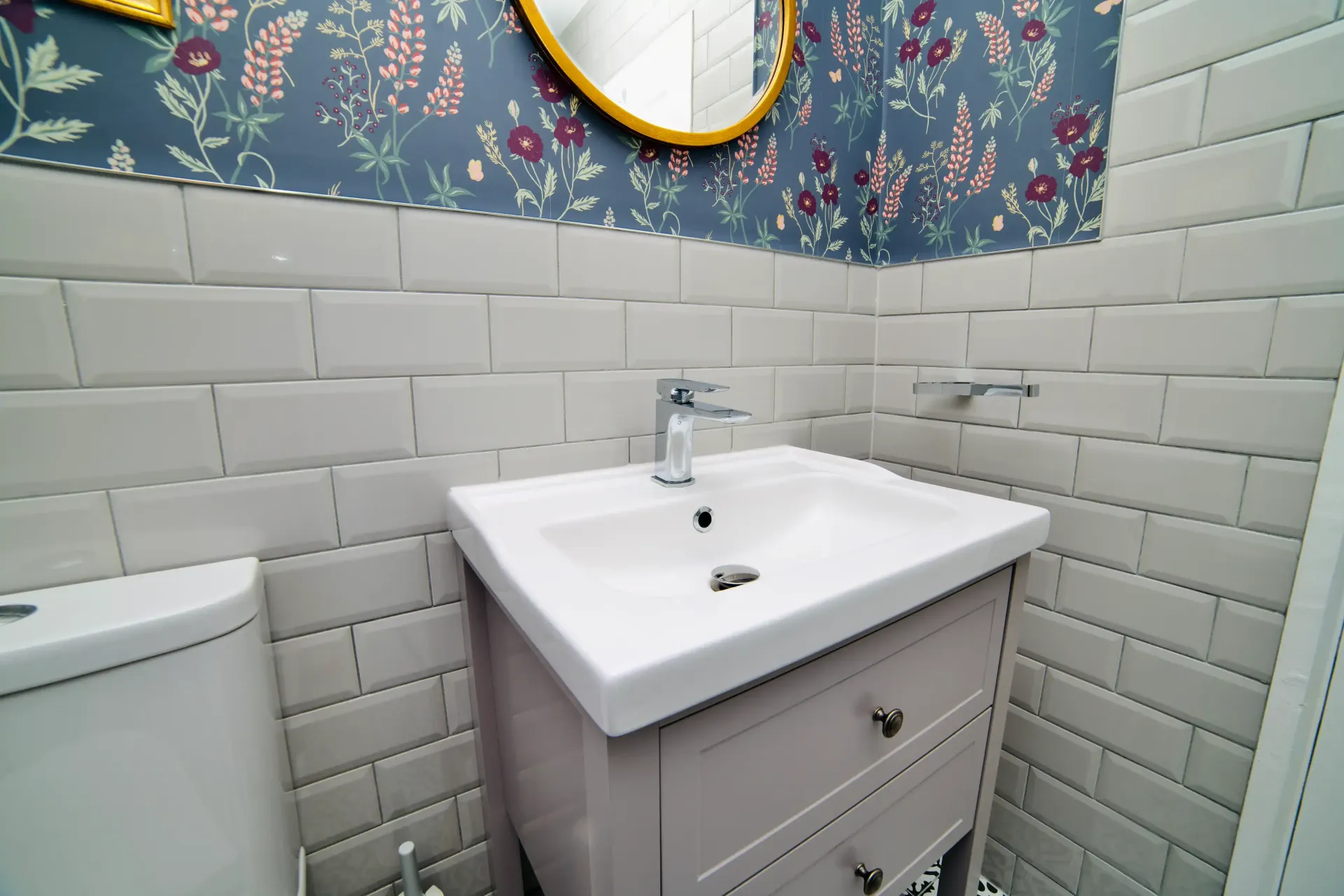 A bathroom with a sink , toilet and mirror.
