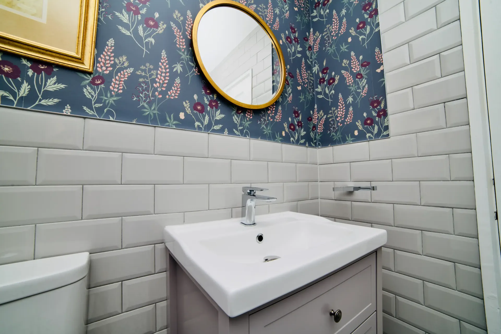 A bathroom with a sink , toilet and mirror