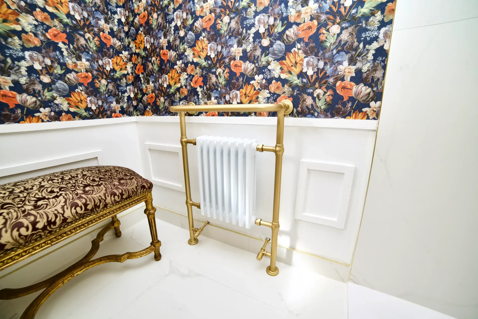 A bathroom with a radiator and a bench.