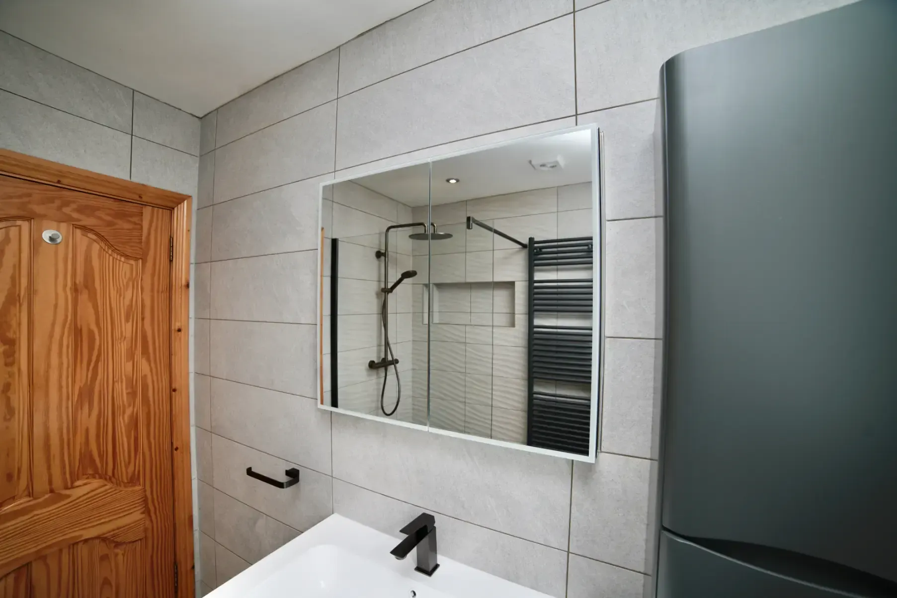 A bathroom with a sink and a mirror on the wall.