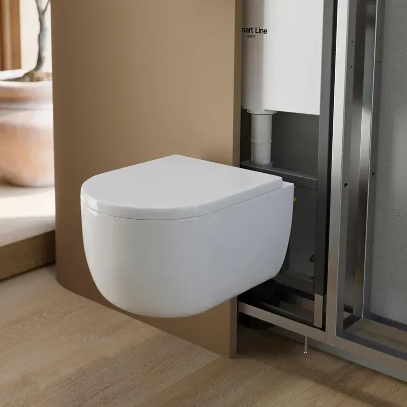 A white toilet is mounted to a wall in a bathroom